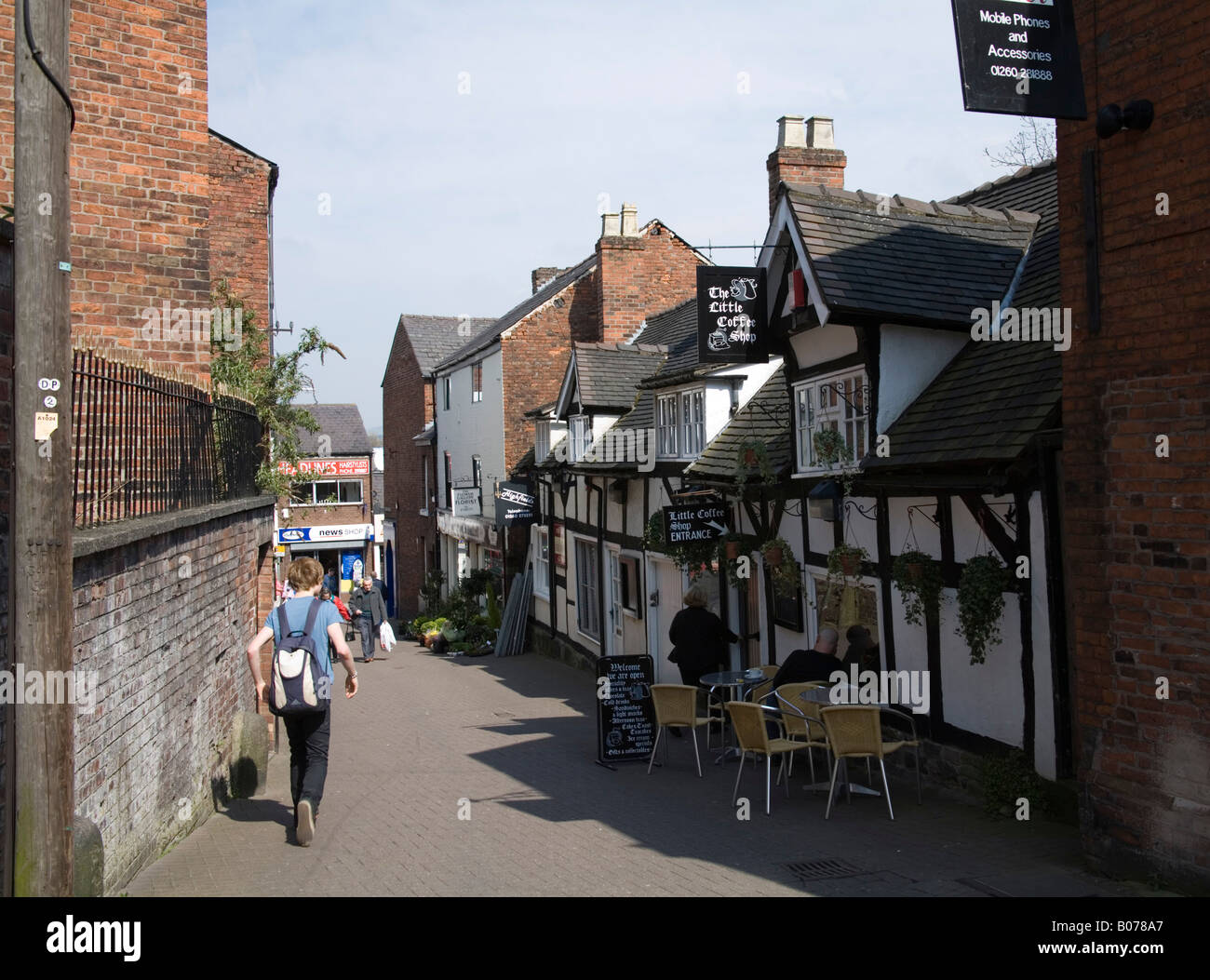 Congleton Cheshire UK April Looking down the aptly named Little Street with man sitting outside the coffee shop Stock Photo