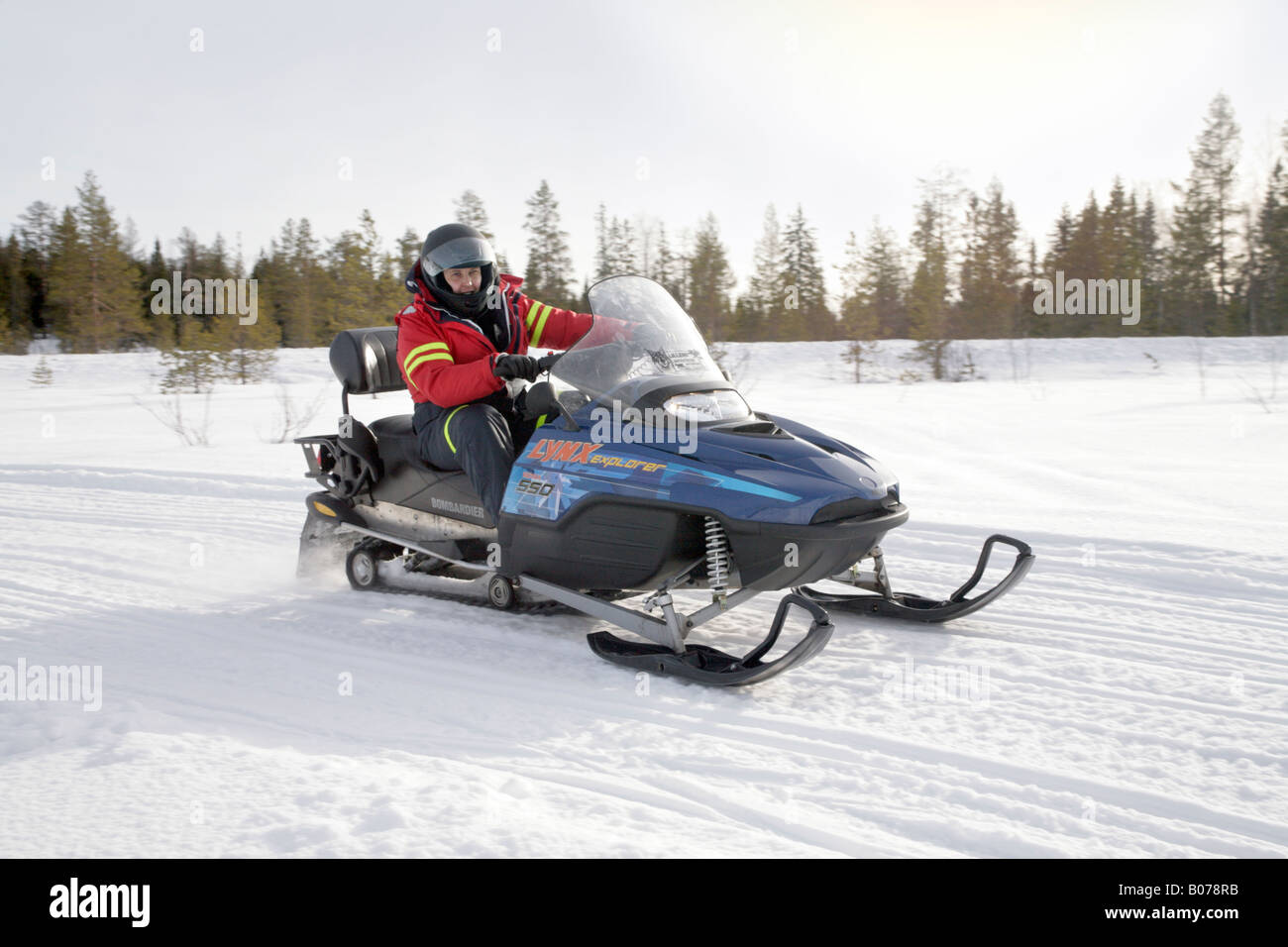 A men in protective sportswear riding snowmobile Branas Ski Resort Sweden Stock Photo