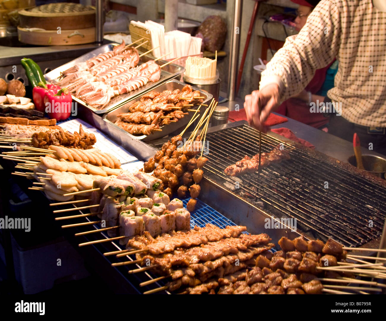 Chinese food vendor market bbq meat skewers cooking Stock Photo Alamy