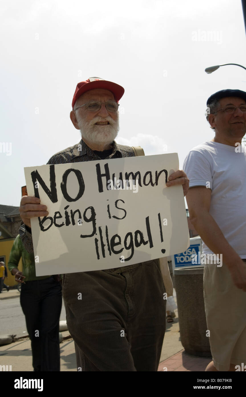 Man holding No Human Being is Illegal sign at a protest of illegal immigration policies in Ann Arbor Michigan USA Stock Photo