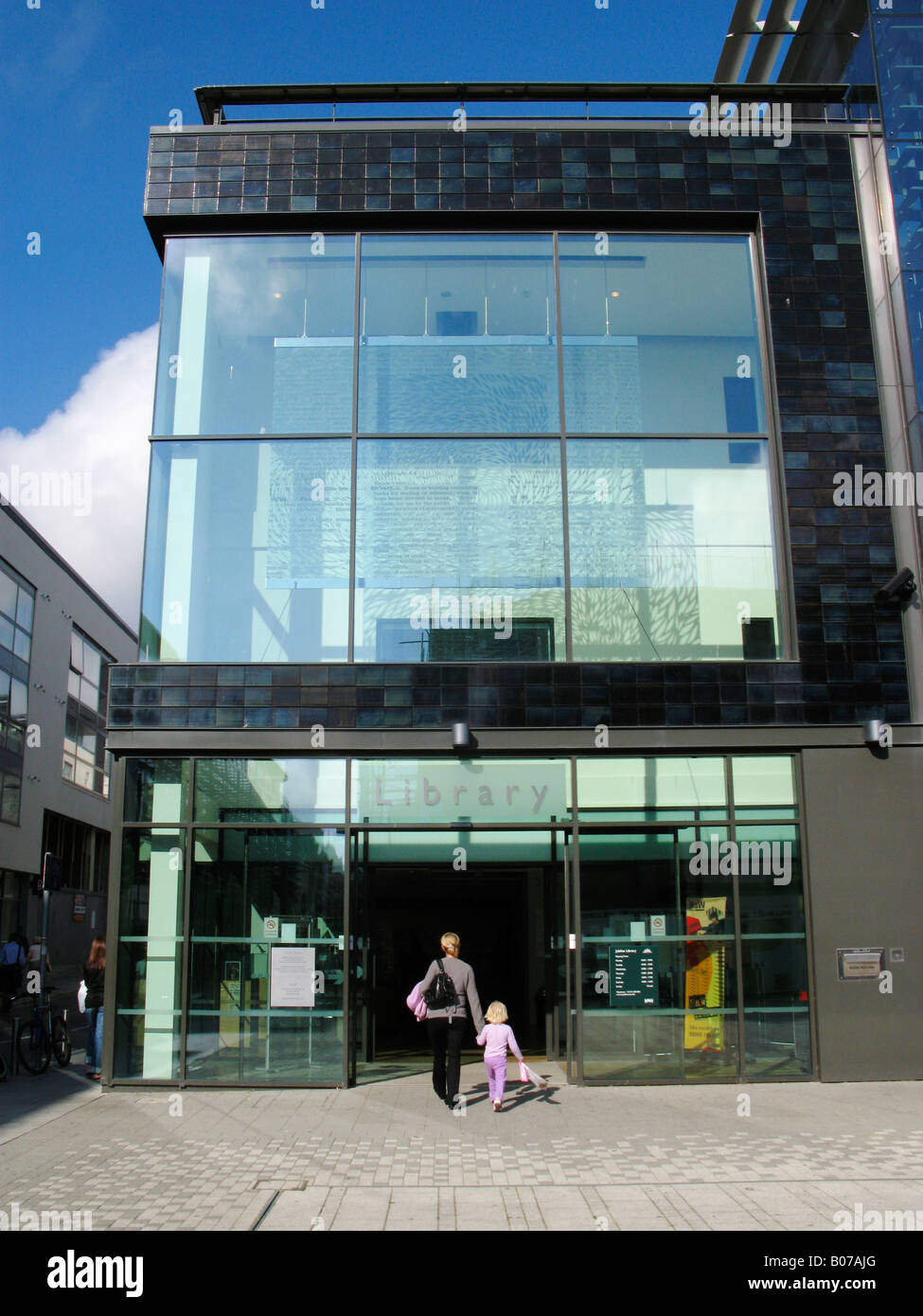 A woman and child walking into the library in Brighton, England Stock Photo