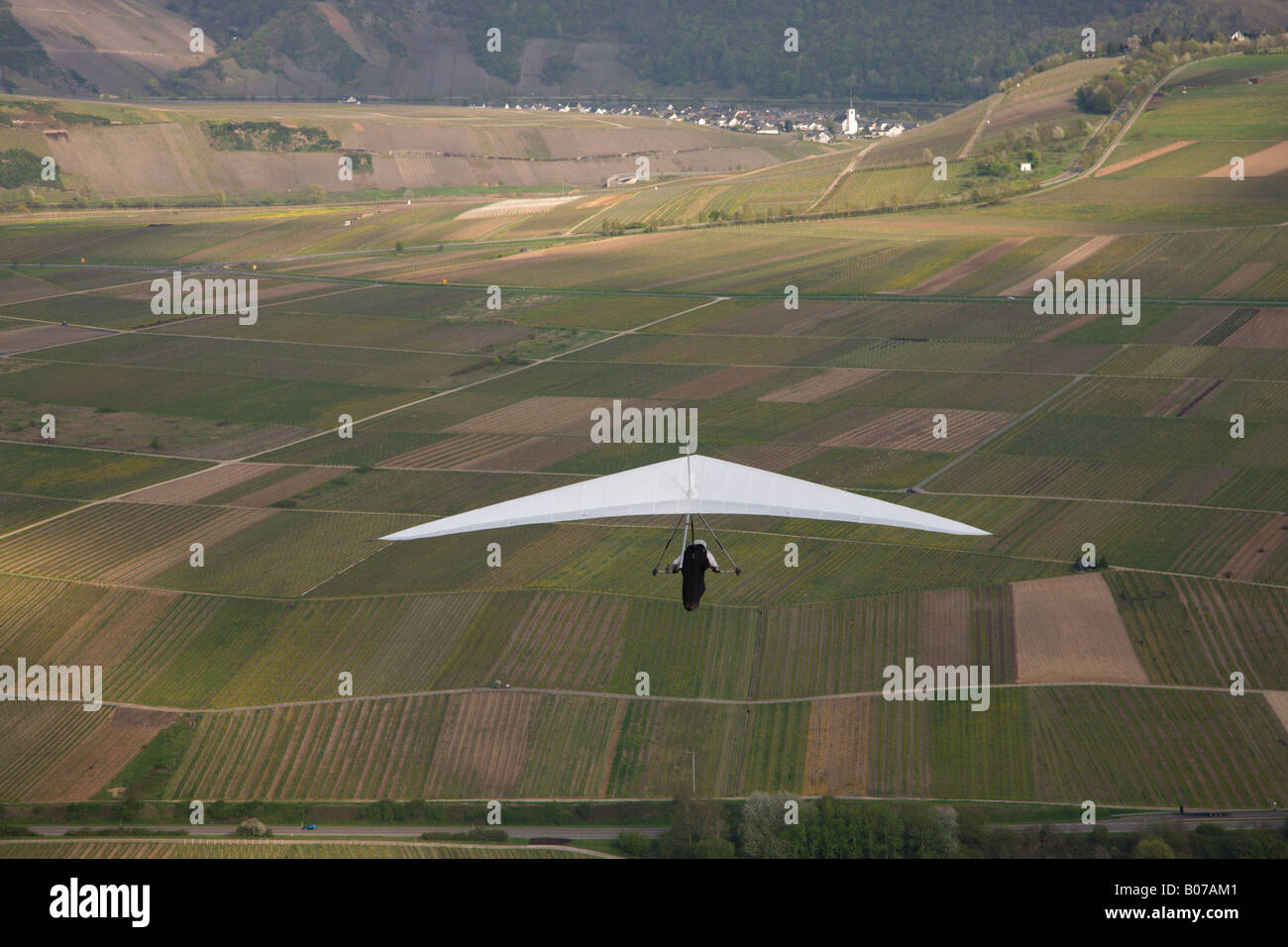 Hang glider soaring over fields in teh Moselle region of German Stock