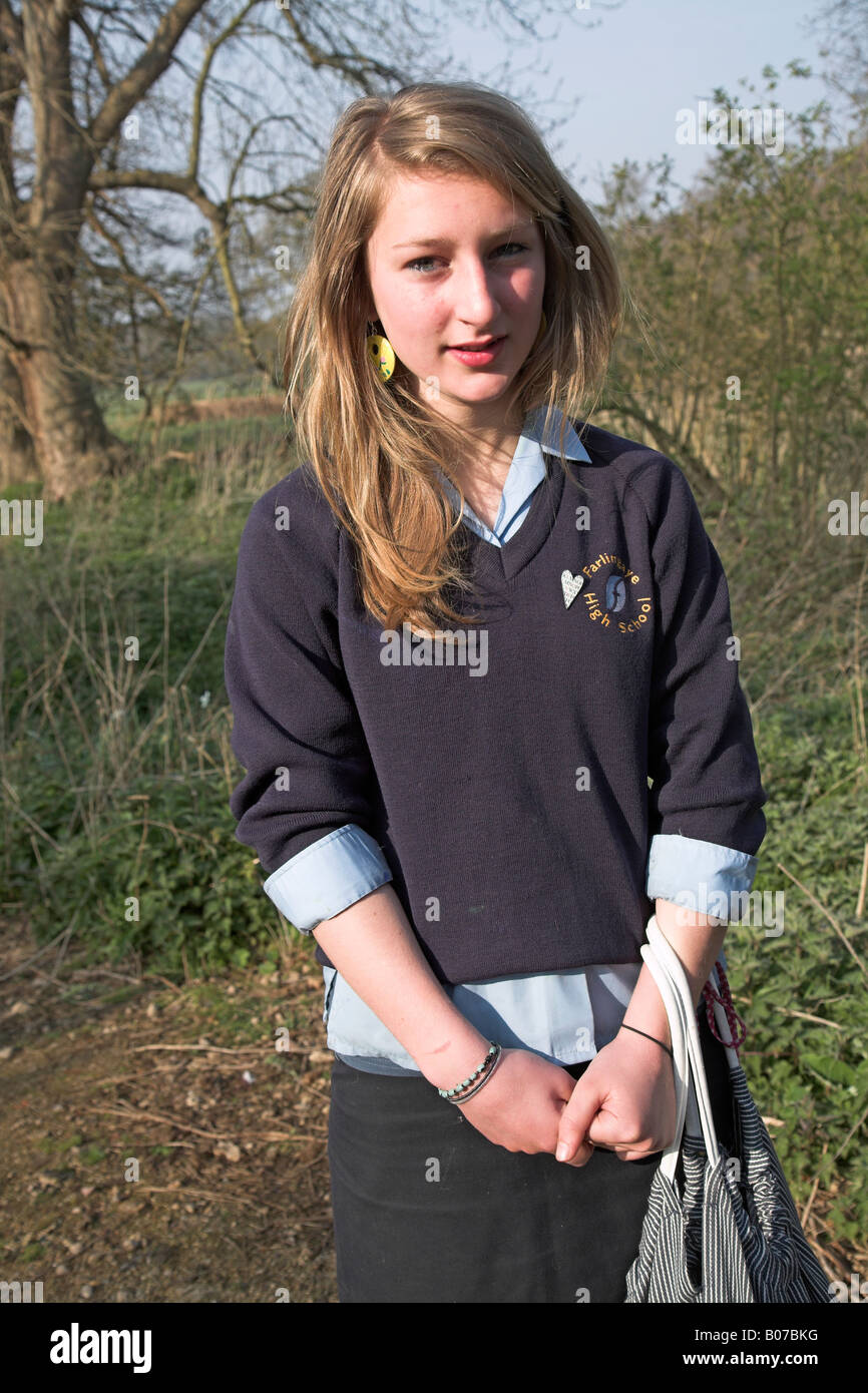 Blonde teenage girl stands in school uniform Stock Photo