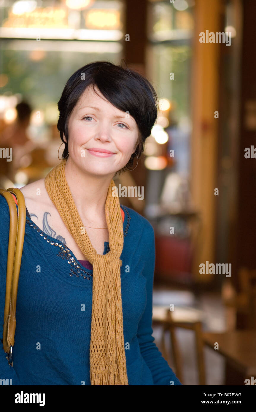 A photo of a woman standing in a cafe Stock Photo - Alamy