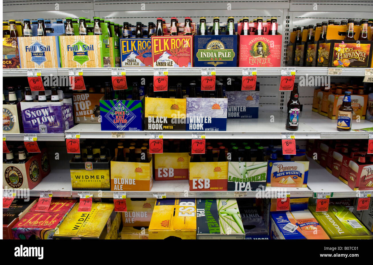 Various six packs and cases of American microbrew beer on shelf in beer isle at a liquor store Stock Photo