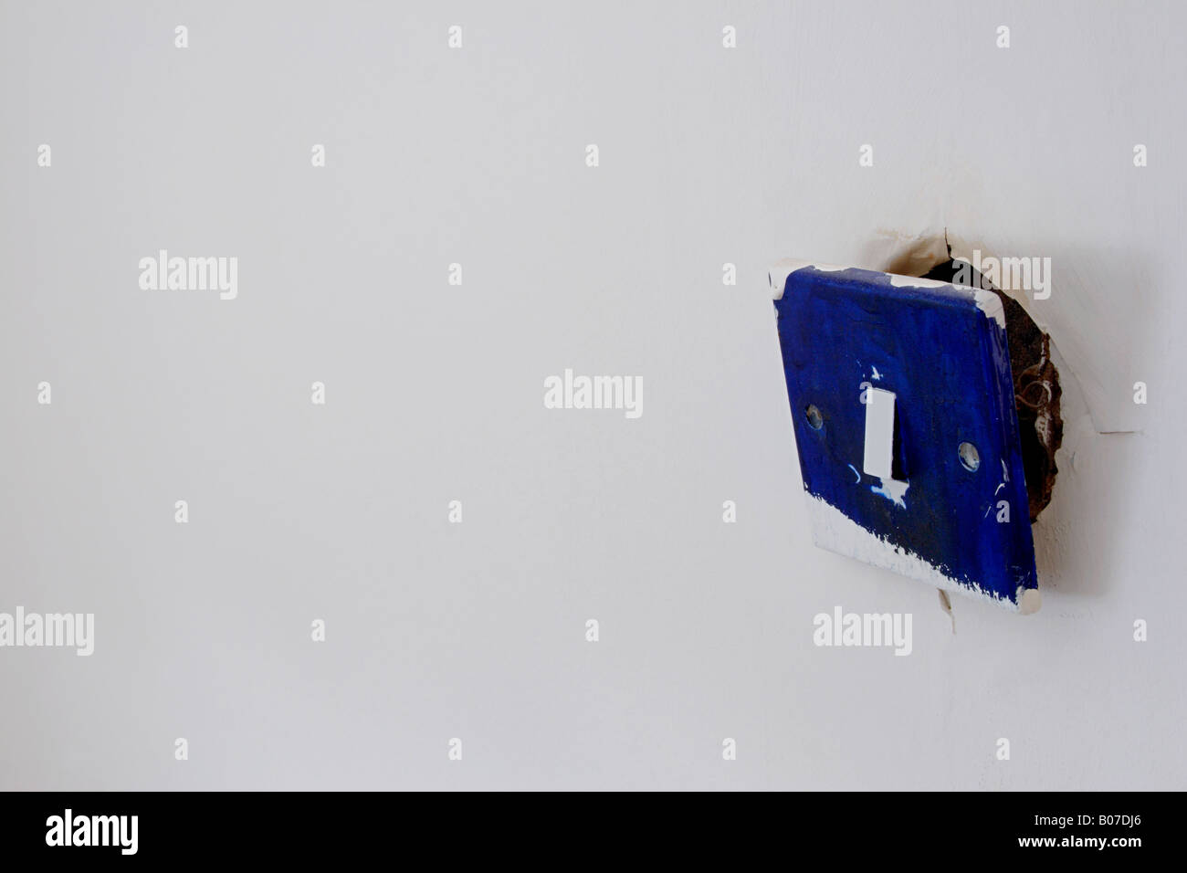 broken blue light switch close up Stock Photo