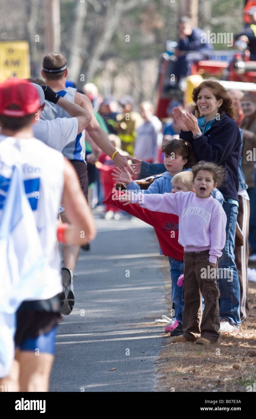 Cheering For Running Racers Children cheering Boston marathon racers Stock Photo - Alamy