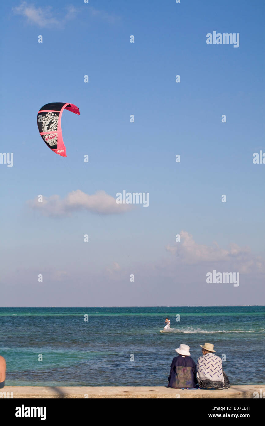 Belize, Caye Caulker, Couple watching man kitesurf Stock Photo