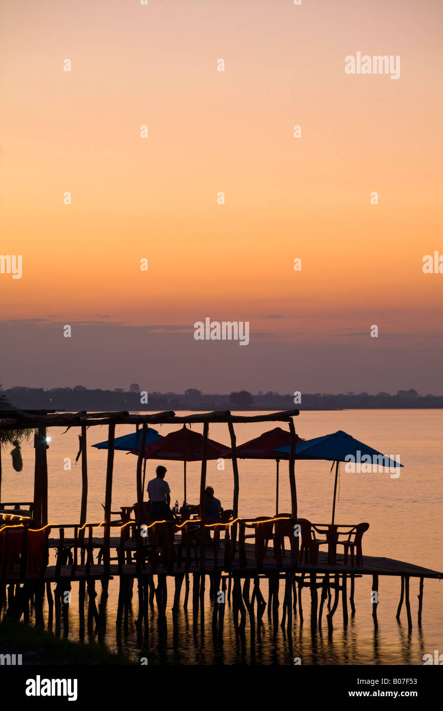Guatemala, El Peten, Flores, Lago de Peten Itza, People eating at lakeside restaurant at sunset Stock Photo