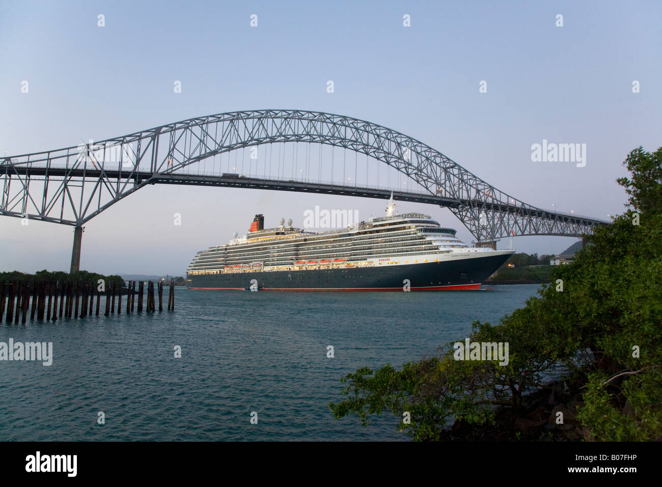Panama, Panama City, The Queen Victoria cruise ship on its maiden World Cruise sailing under the Bridge of the Americas Stock Photo
