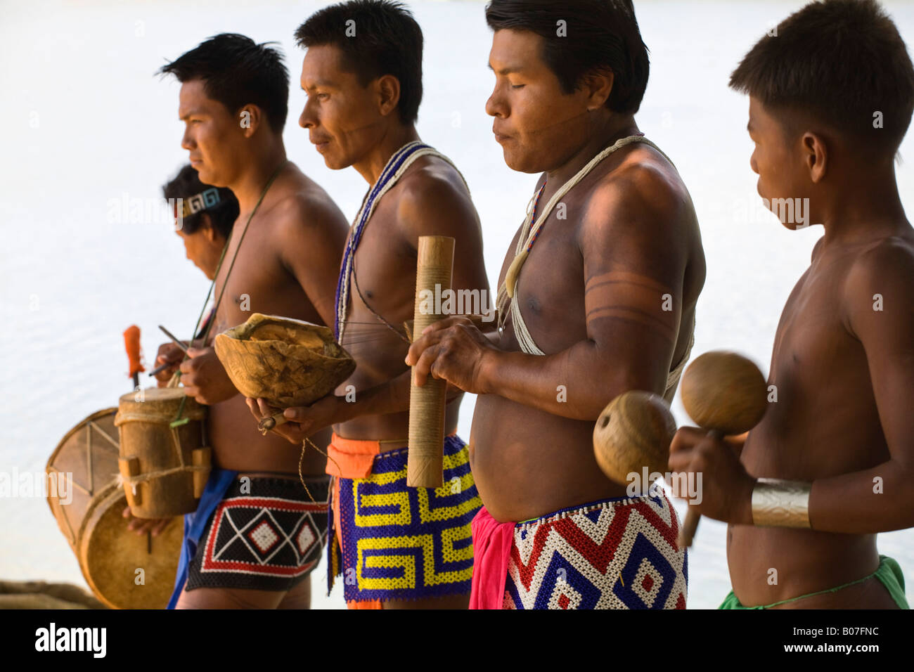 Panama, Chagres River, Embera Village, Embera men playing instruments ...
