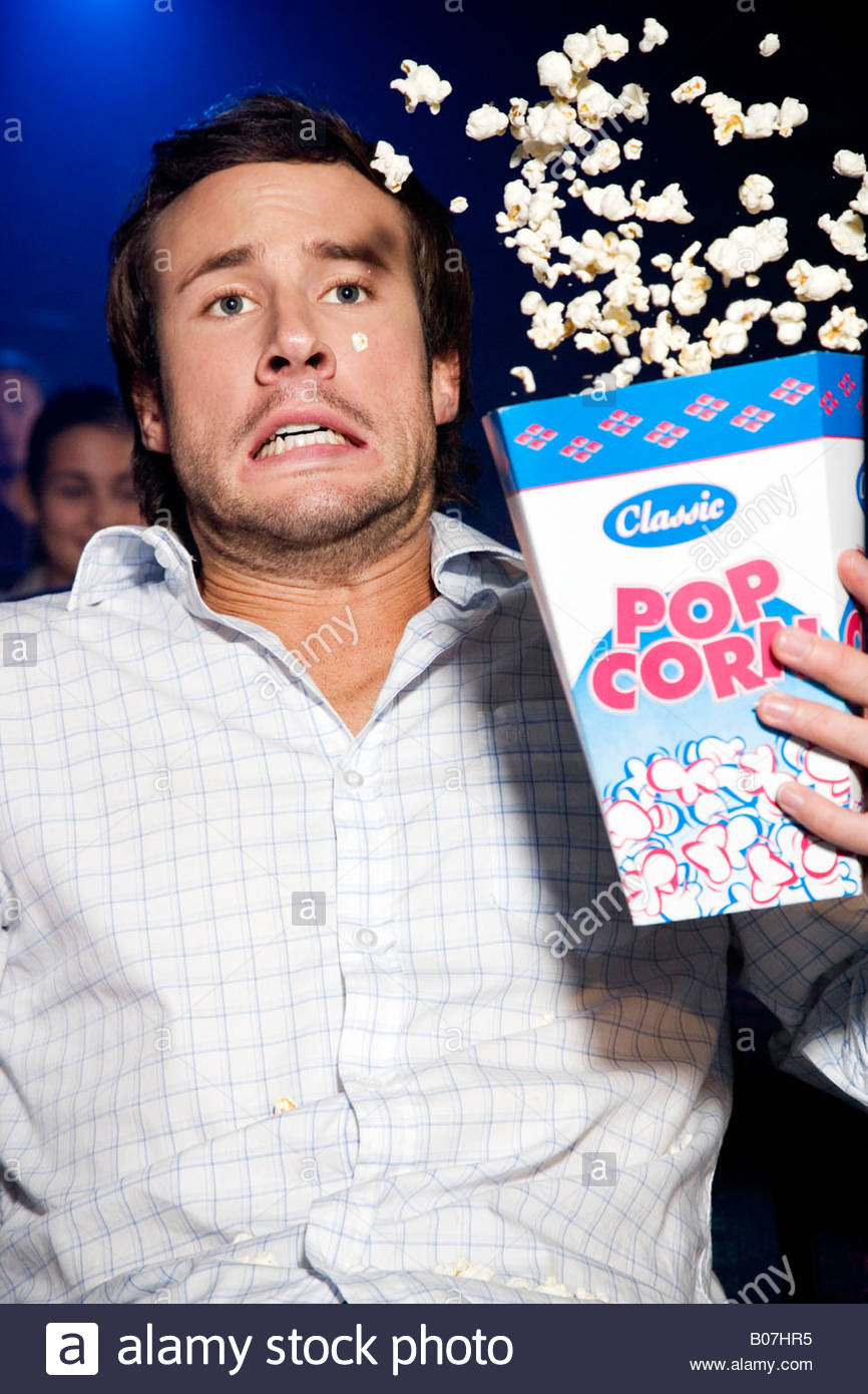 man-throwing-his-popcorn-in-the-air-in-reaction-to-the-film-hes-watching-B07HR5.jpg