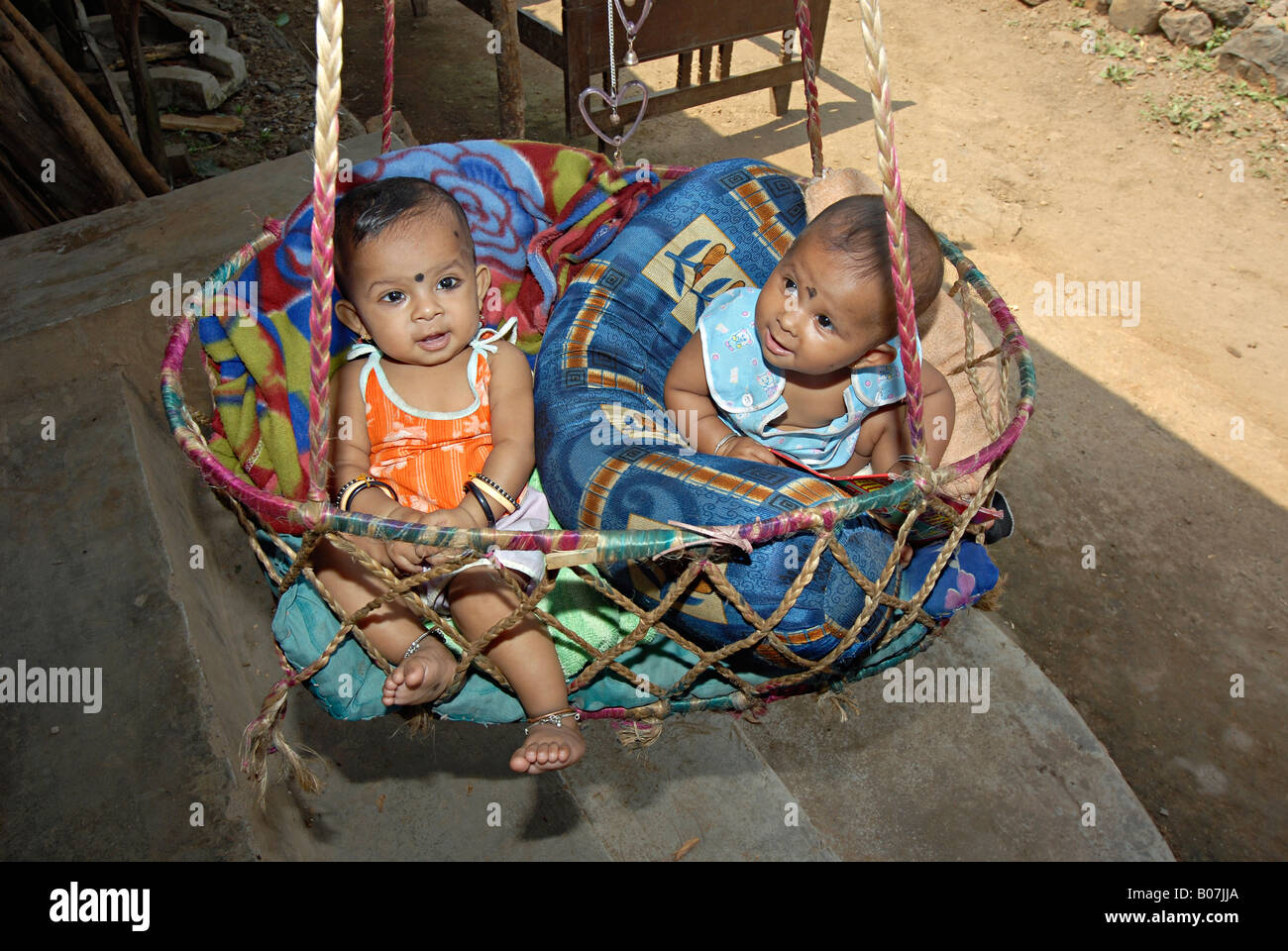 Twins in a hammock. Kokna tribe Stock Photo