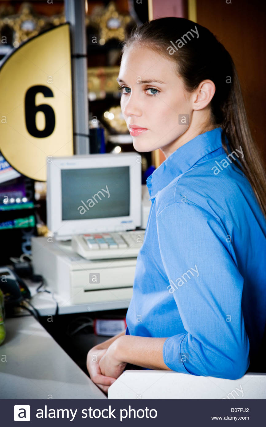 Portrait of a bored supermarket checkout assistant Stock Photo, Royalty ...