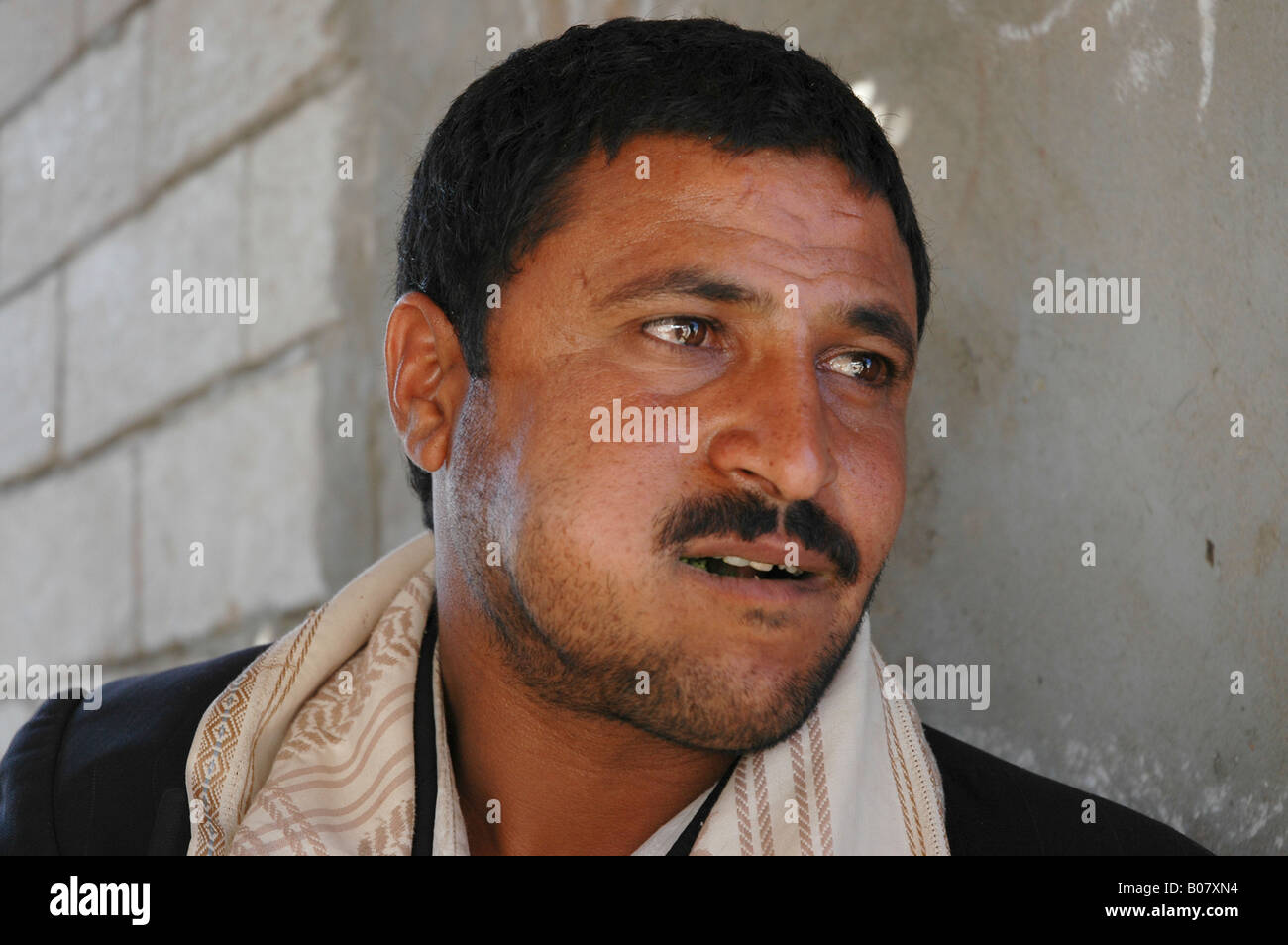 A man with one cheek bulging from the qat he has chewed for hours is a common sight across Yemen Stock Photo