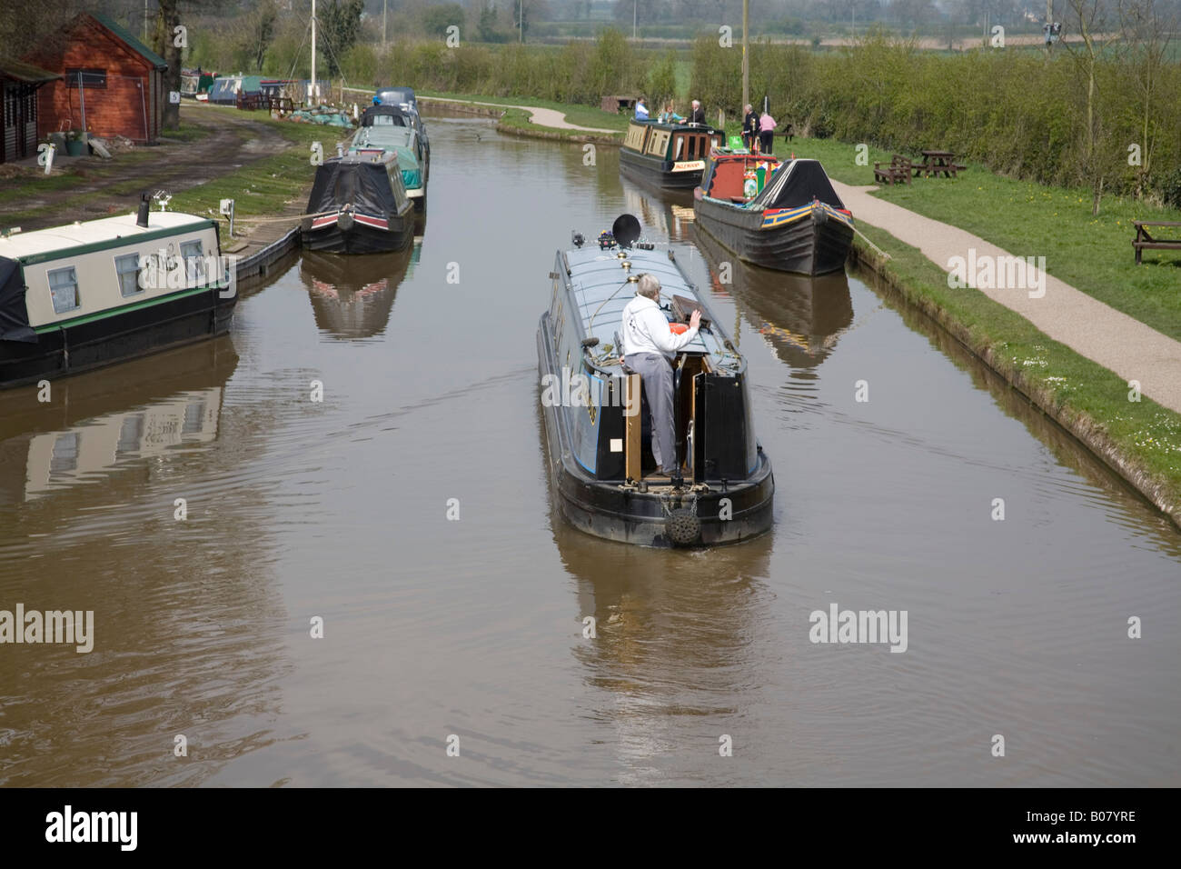 NANTWICH CHESHIRE April A pale blue narrowboat travelling along the Shropshire Union Canal Stock Photo