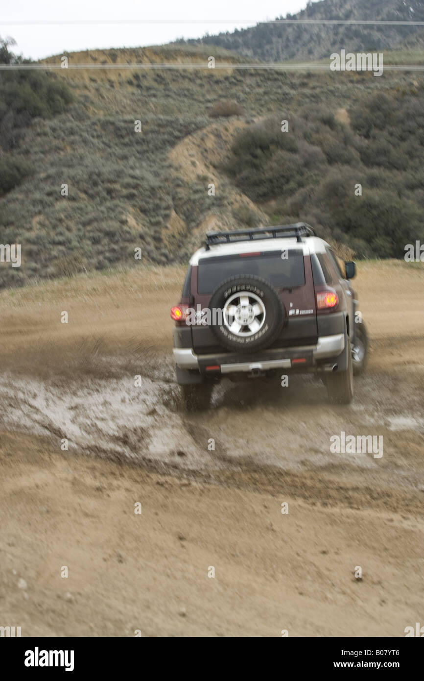 Toyota FJ Cruiser runs through mud trail Stock Photo Alamy
