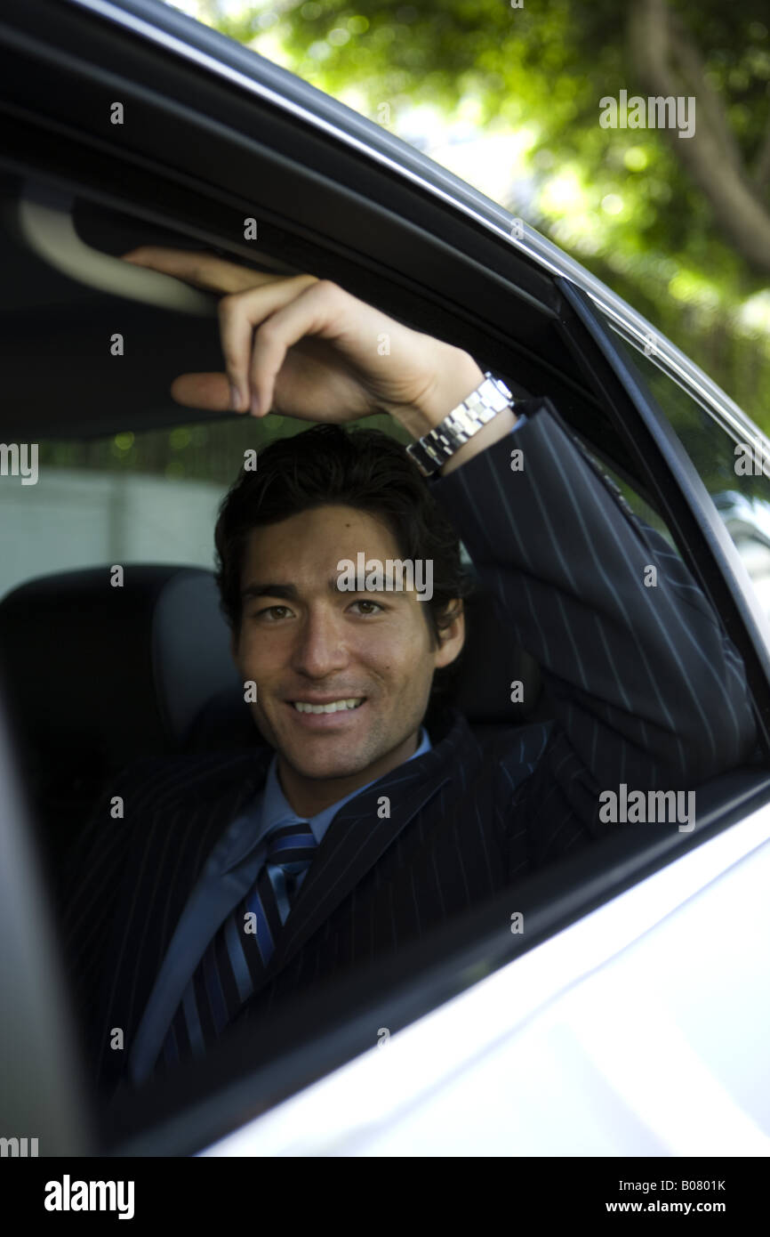 Asian businessman seated in rear passenger seat of car Stock Photo Alamy