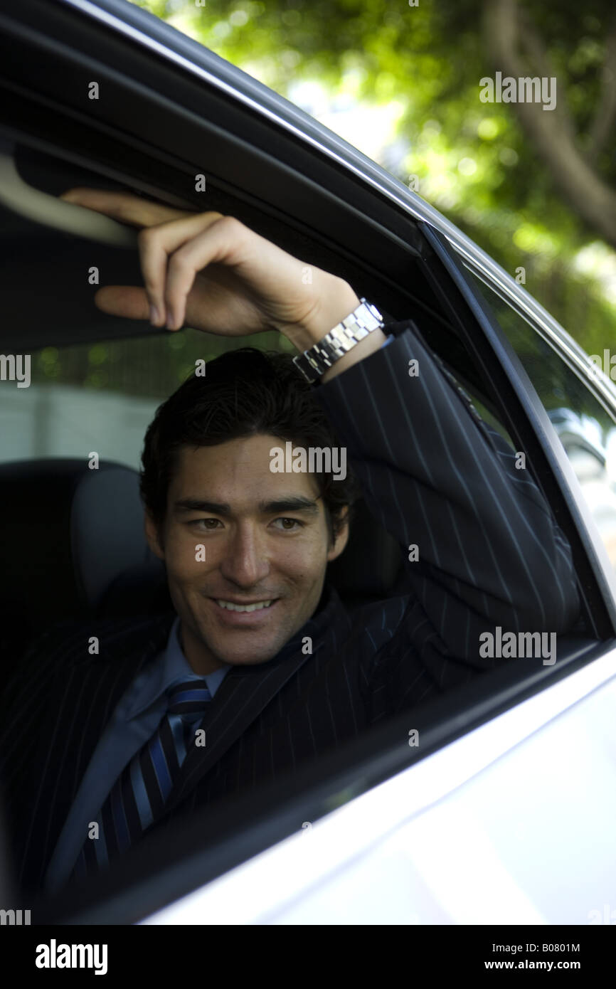 Asian businessman seated in rear passenger seat of car Stock Photo Alamy