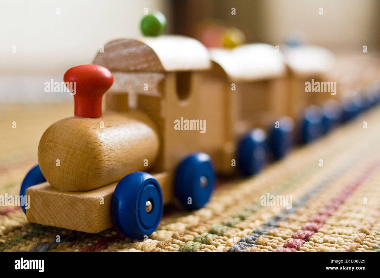 Wooden toy train on carpet Stock Photo Alamy