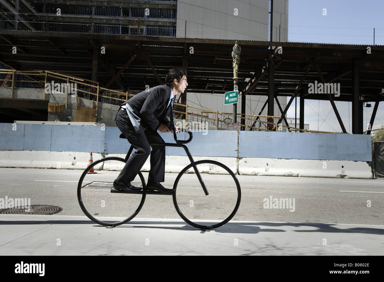 Businessman riding vintage bicycle on pavement Stock Photo Alamy