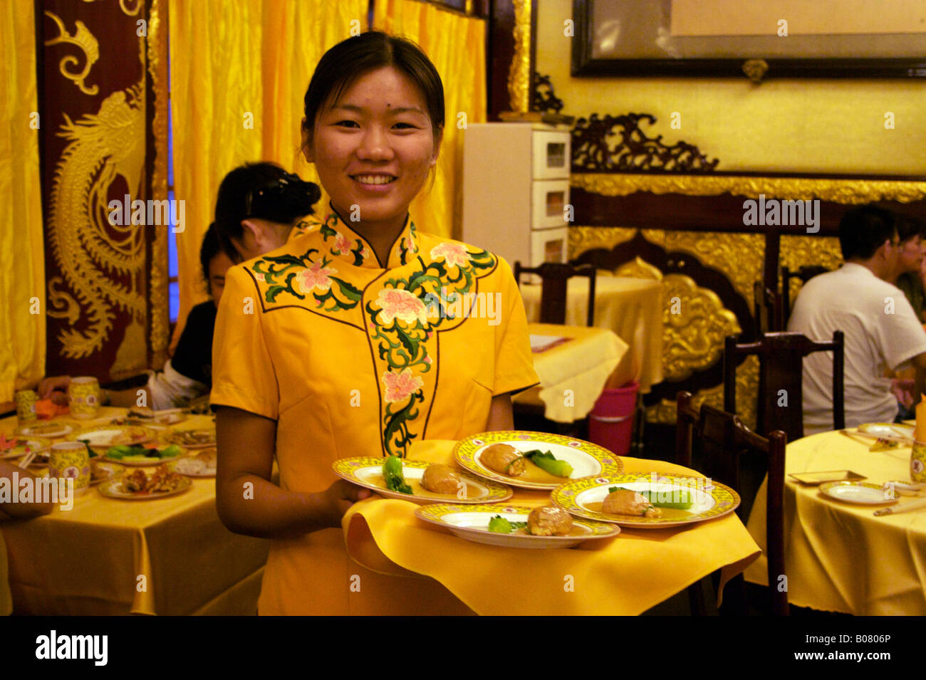 A waitress at the Fang Shan restaurant which originally served food to the royal family Yilantang Bei Hai Park Beijing China Stock Photo