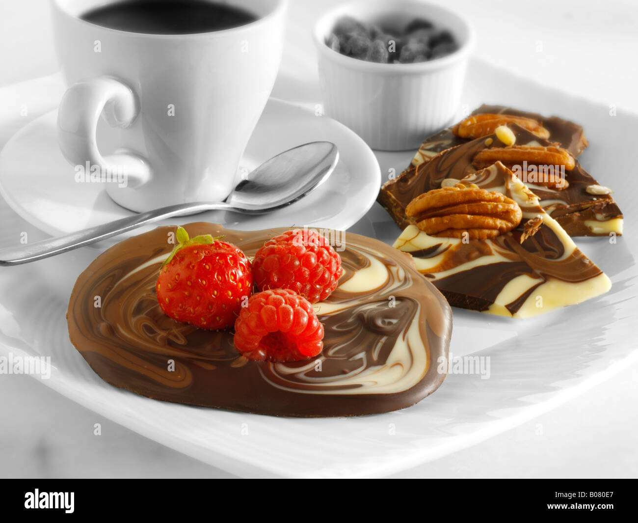 Milk chocolate rounds with nuts and raspberry Stock Photo - Alamy