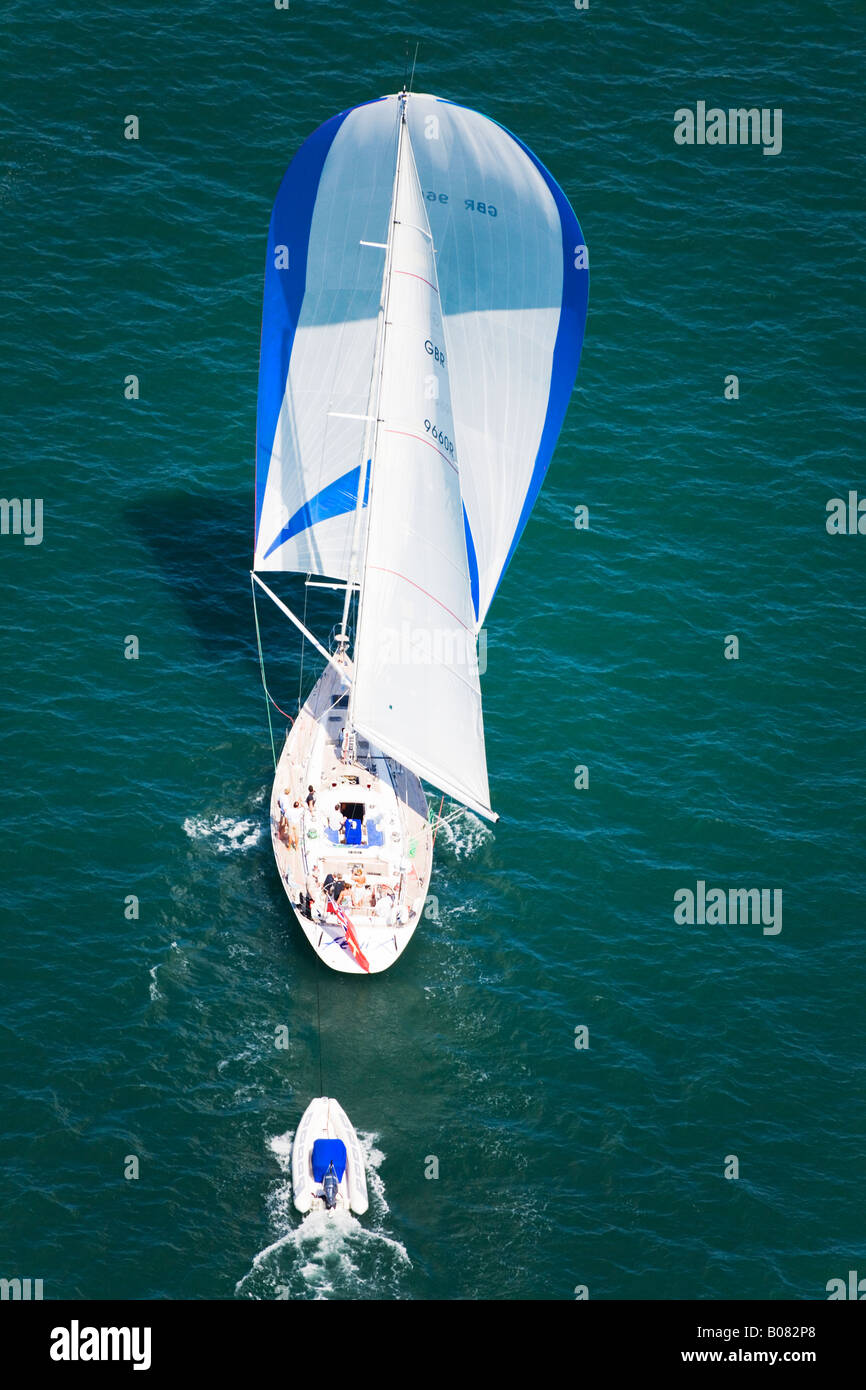 Aerial view of a large luxury yacht trailing a tender. Stock Photo