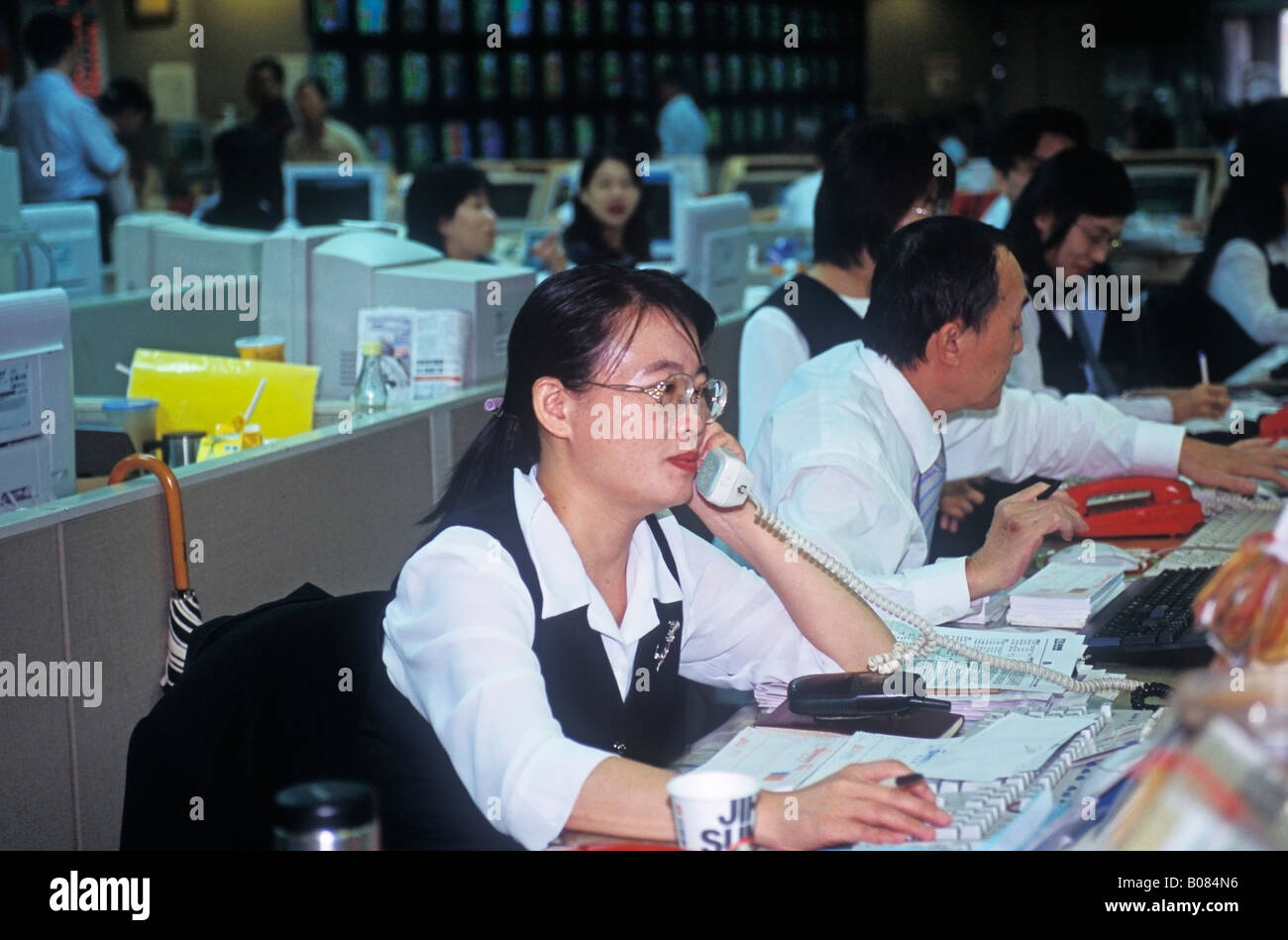 Woman Working At Stock Trading Desk Taiwan China Stock Photo