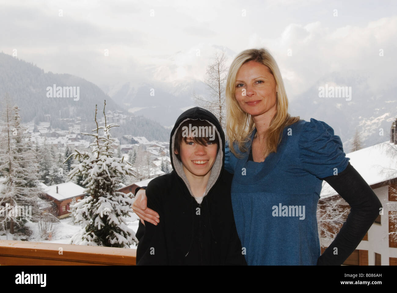 mother and son on a chalet balcony in Verbier Stock Photo