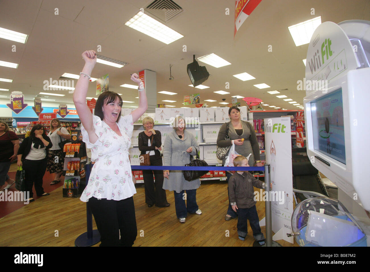Customers try out the Nintendo WiiFit at Woolworths, Lakeside shopping centre, Essex. Stock Photo
