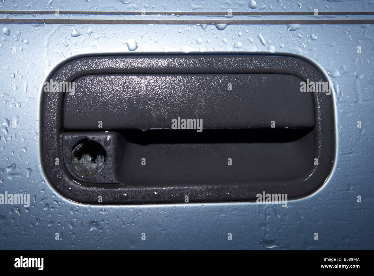 Door lock of a Vauxhall Cavalier showing where thieves ripped the lock out of the door in November 2007 Stock Photo