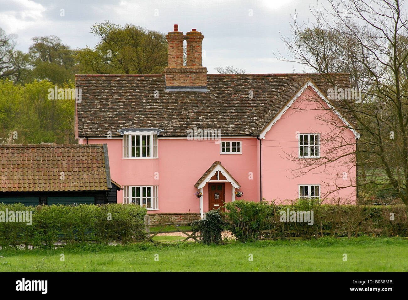 Stone built Pink coloured Tudor Thatched Cottage Abbots Ripton village Cambridgeshire England Britain UK Stock Photo