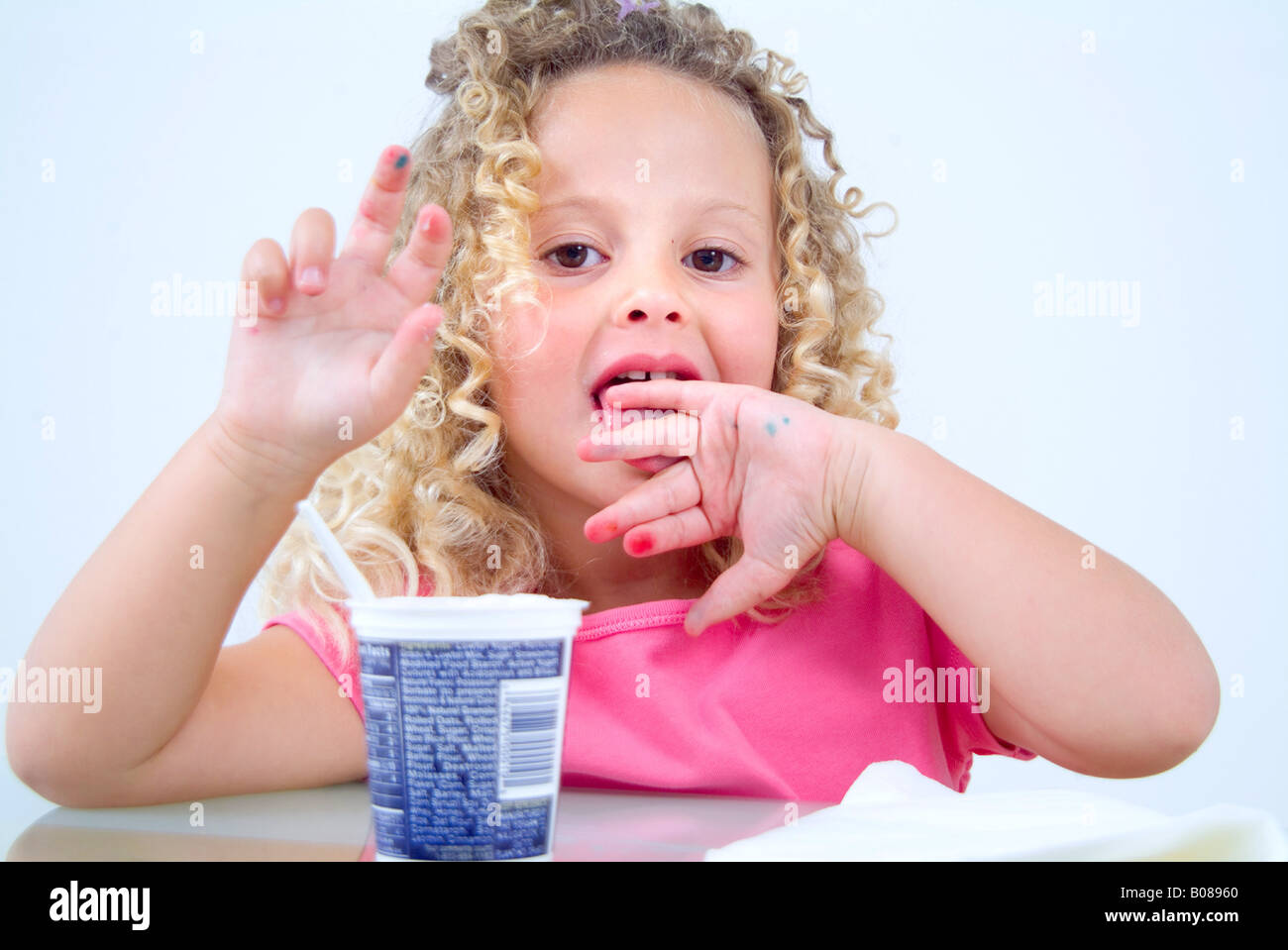Little girl licking hands clean Stock Photo Alamy