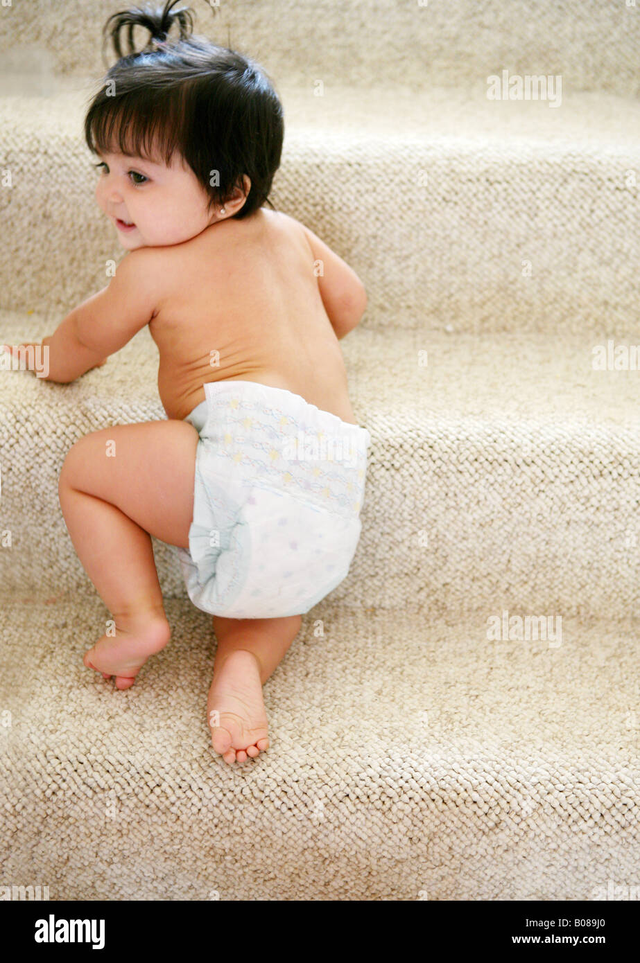 Baby girl learning to climb stairs Stock Photo Alamy