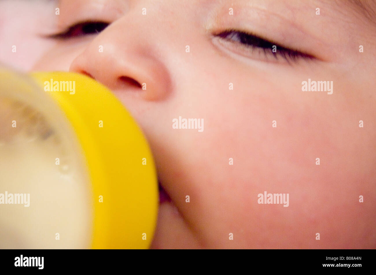 Baby sleeping with bottle in mouth Stock Photo Alamy