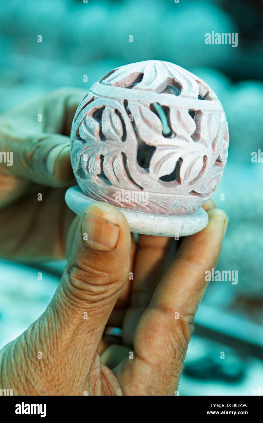 Closeup of hand holding carved stone Indian souvenir Mumbai (Bombay