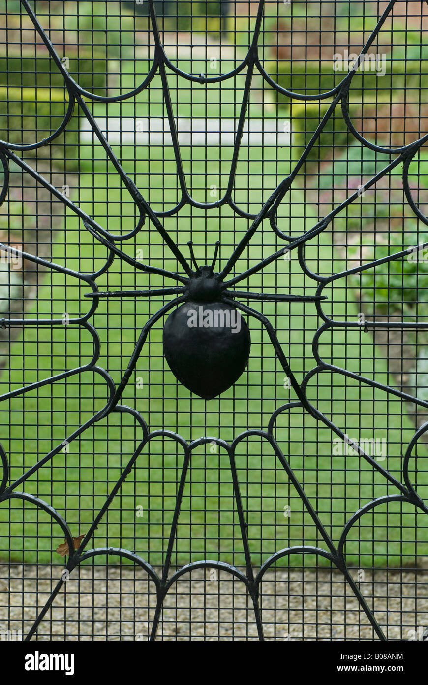 spiders web on wrought iron gate in garden Stock Photo