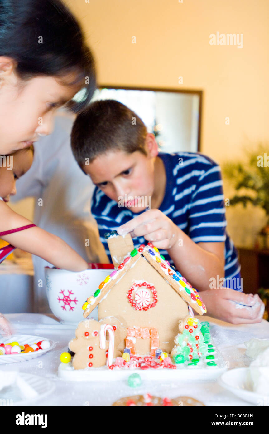 Boy Decorating Gingerbread House Stock Photo Alamy   Boy Decorating Gingerbread House B08BH9 