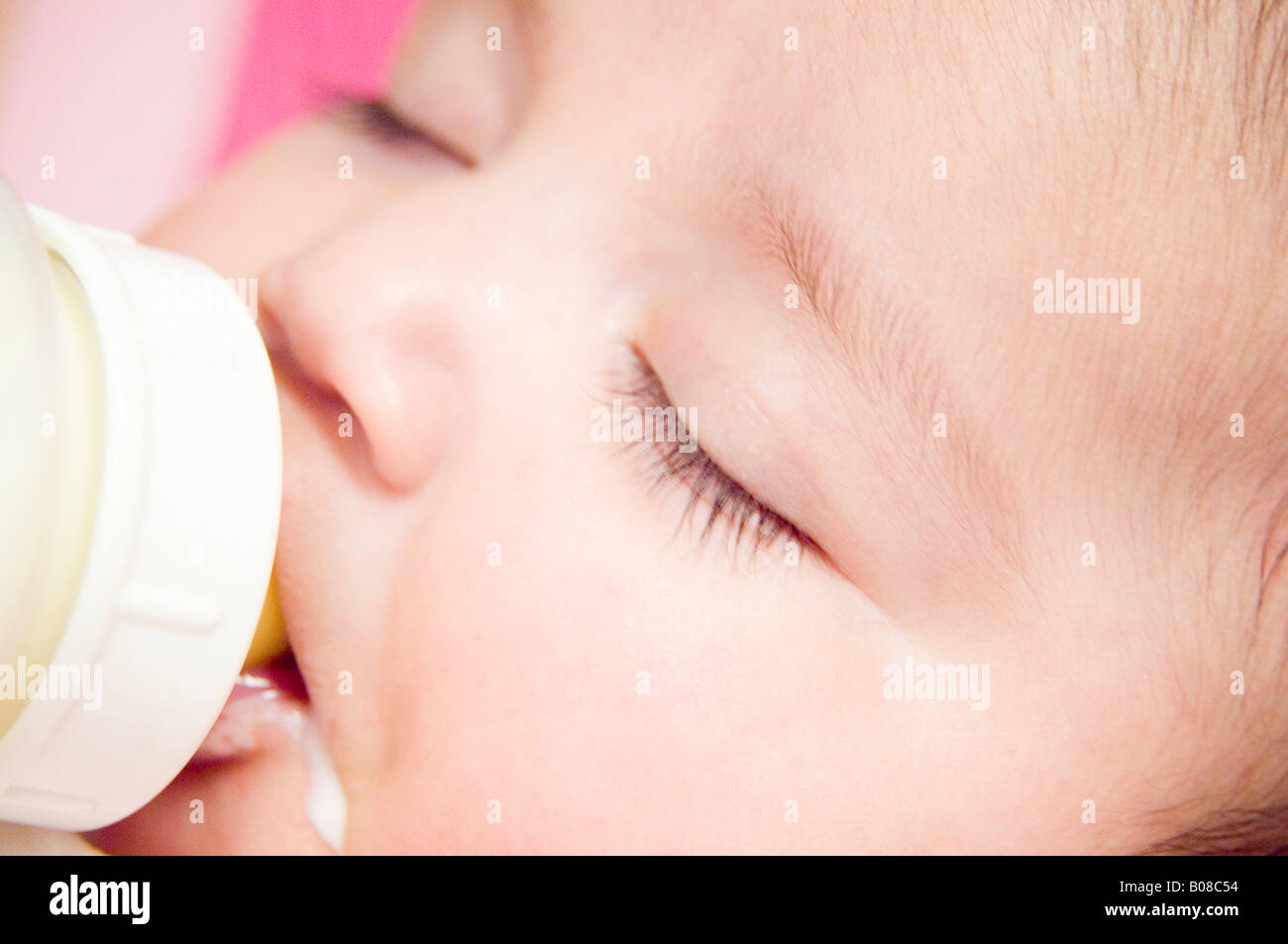 Baby sleeping with bottle in mouth Stock Photo Alamy