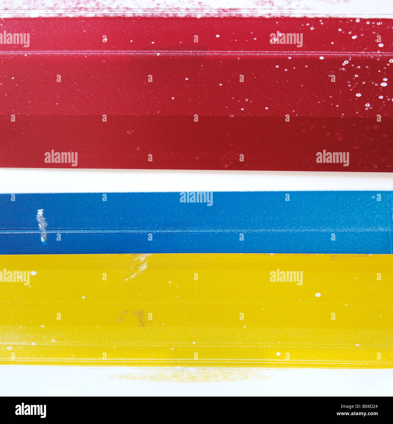red, blue and yellow printer blotting papers with streaks and spots