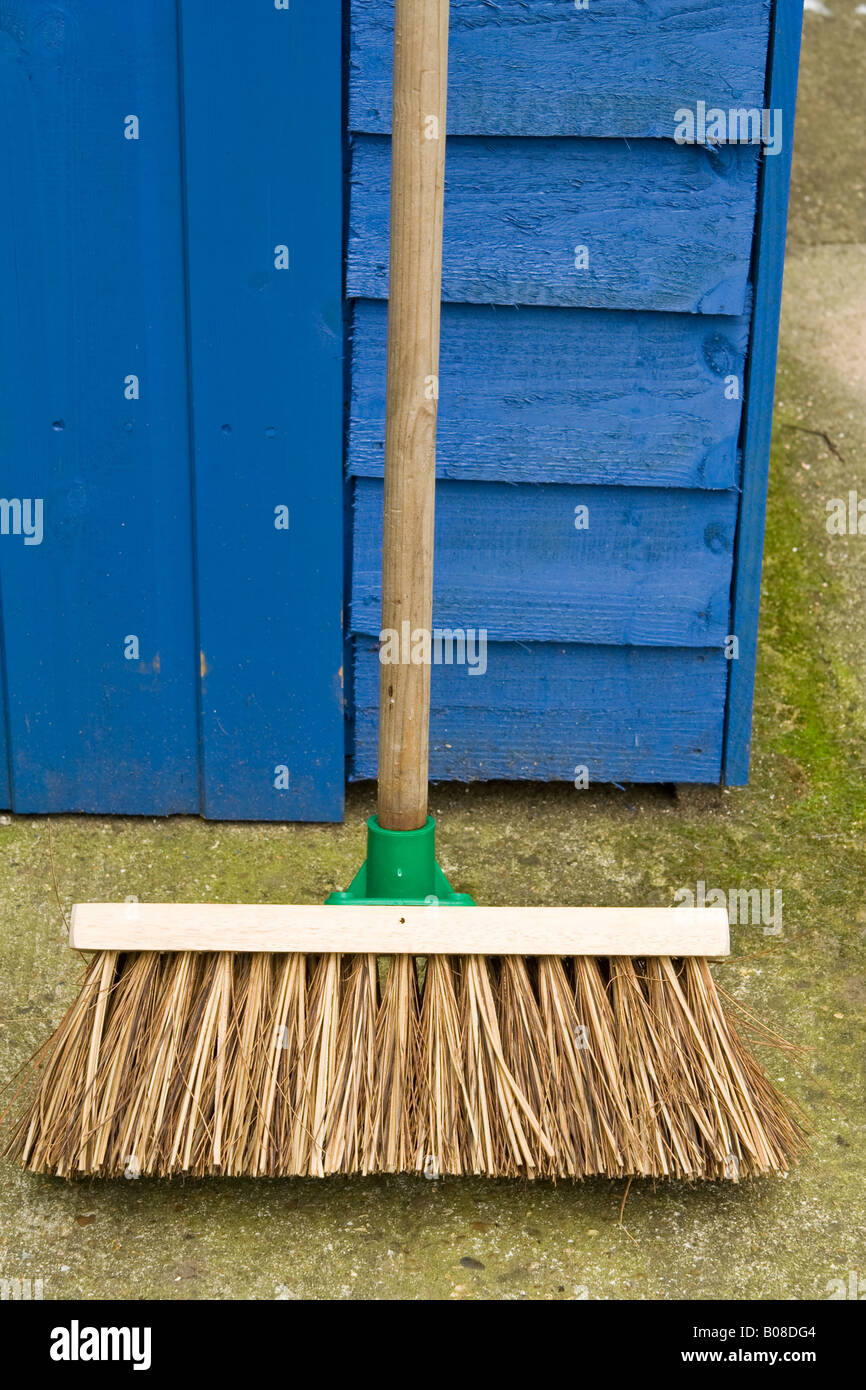 A new broom leaning up against a ^garden shed, UK. Stock Photo