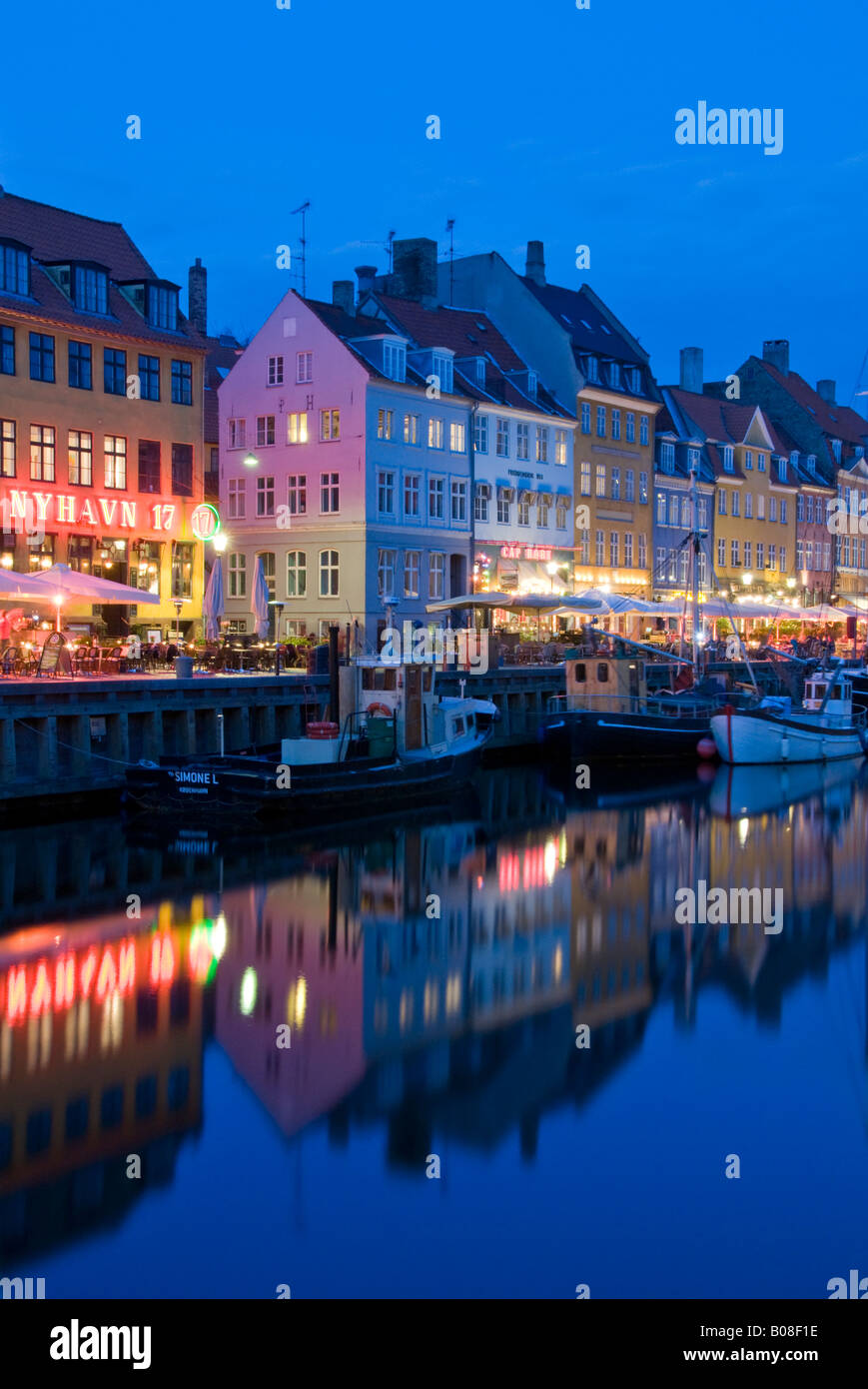Historic Old Boats Moored Alongside Nyhavn Quayside at Night, Nyhavn, Copenhagen, Denmark, Europe Stock Photo
