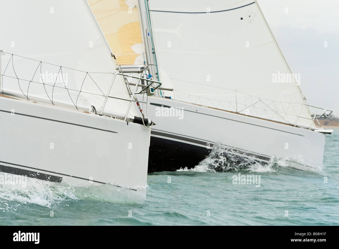 Close up on the bows of two racing yachts in close competition Stock Photo