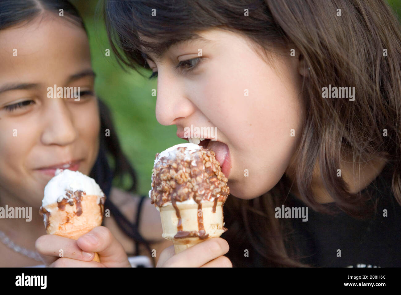 Two preteen girls eating ice cream cone Stock Photo