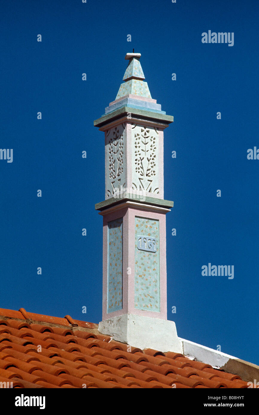 even small fishermens cottages have individual intricate chimneys on their tile roofs in the Algarve region of Portugal Stock Photo
