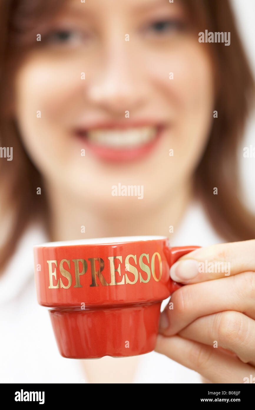 Woman holding an espresso Stock Photo - Alamy