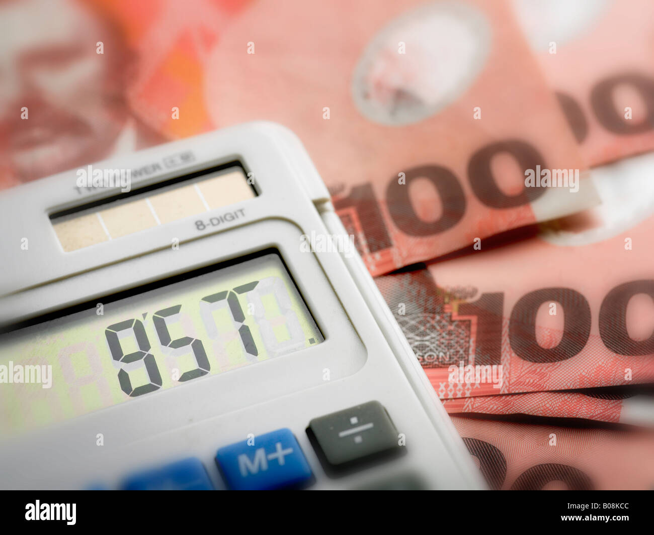 gst on screen of calculator with new zealand 100 hundrend dollar notes