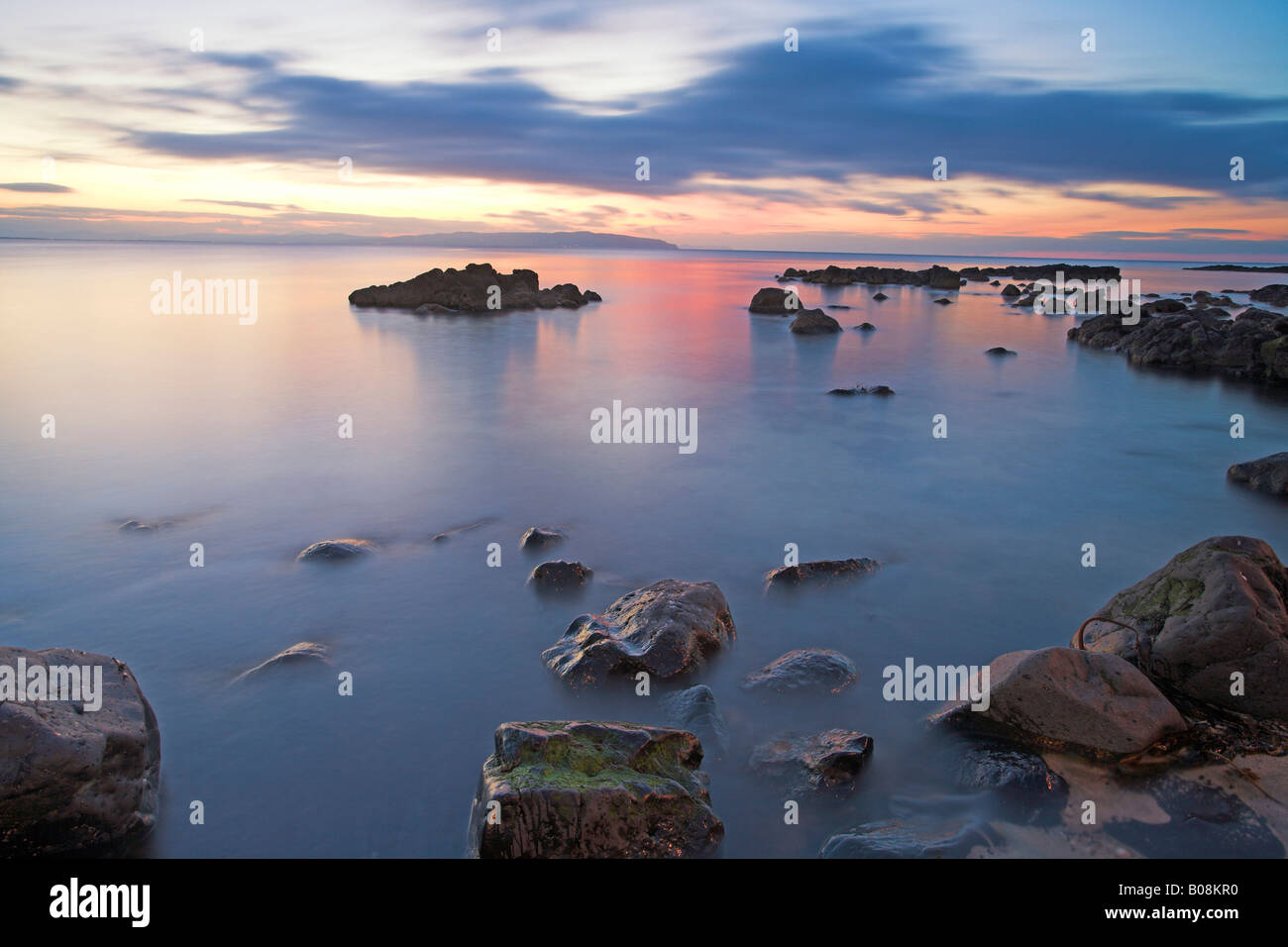Calm Sea Setting setting sun reflected in calm waters of the Irish Sea off Co Antrim ...
