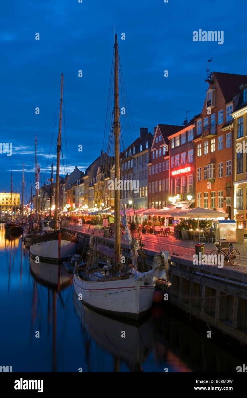 Historic Old Boats Moored Alongside Nyhavn Quayside at Night, Nyhavn, Copenhagen, Denmark, Europe Stock Photo